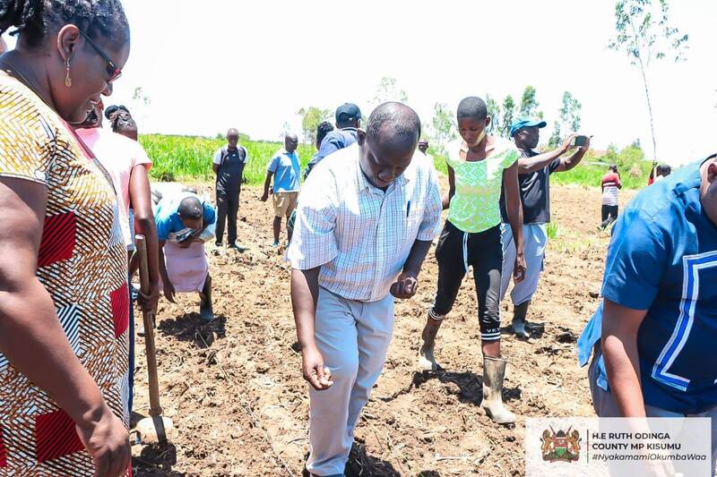 Nyakamami Foundation Manager Mr Solomon Amuti tries his hand at planting Nyota bean variety in Kapuothe